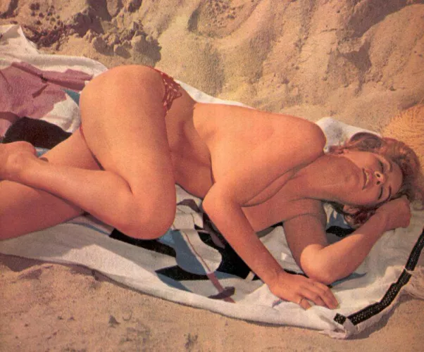Lana Dale napping on the beach in Malibu [1960]