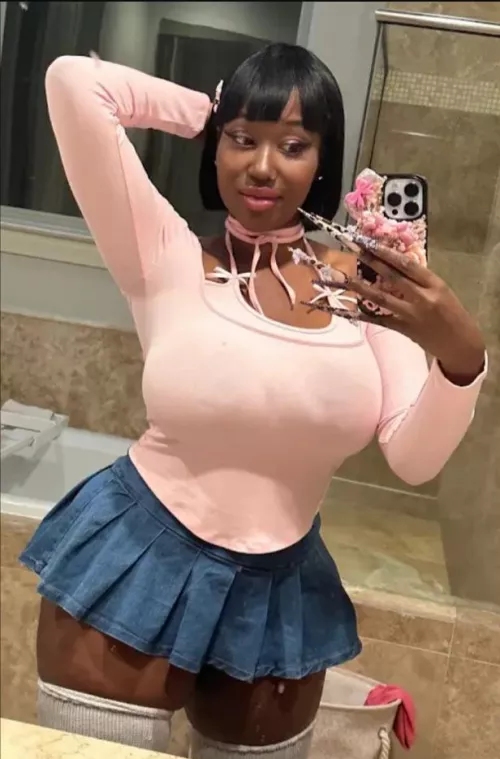 Black girl in white shirt and short skirt.