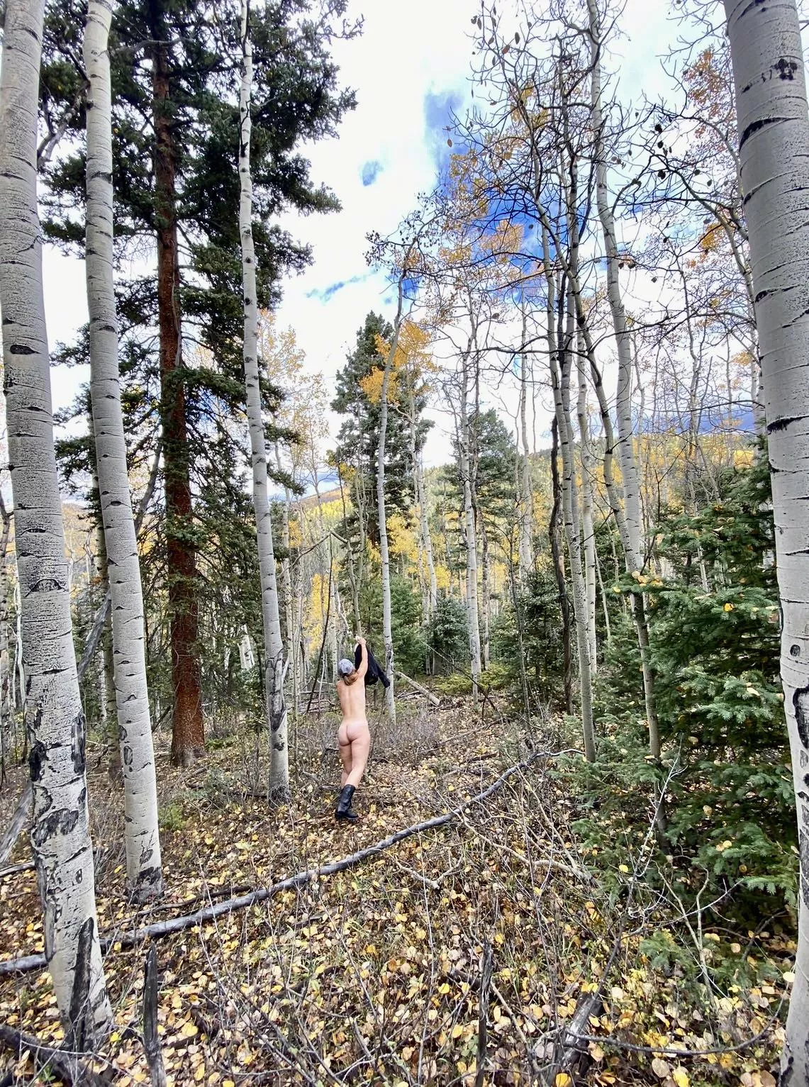 When posing nude outdoors, “nature’s coat rack” comes in handy.