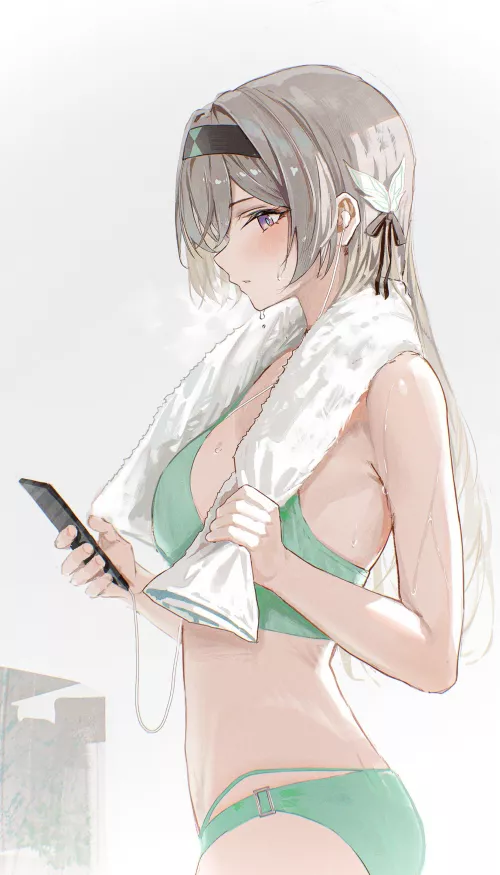 Checking her phone after a shower