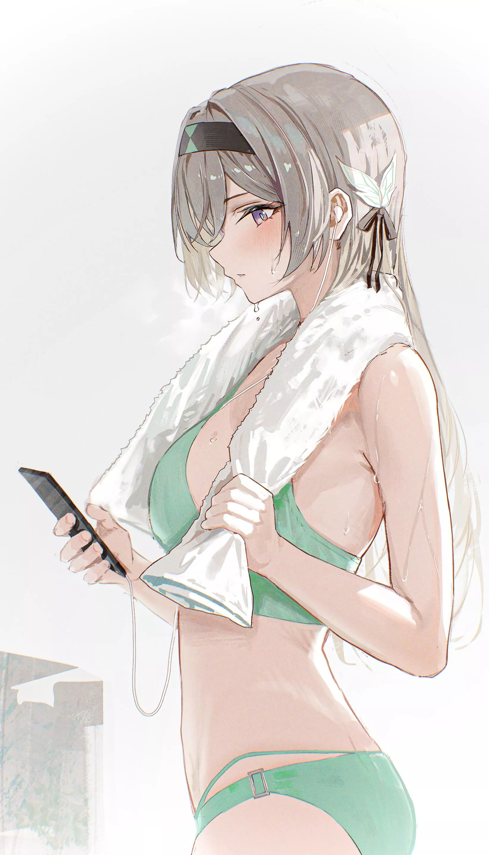 Checking her phone after a shower