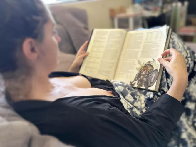 Just a mom reading up on dungeons and dragons with her tits out. You can be sexy and nerdy at the same time right?