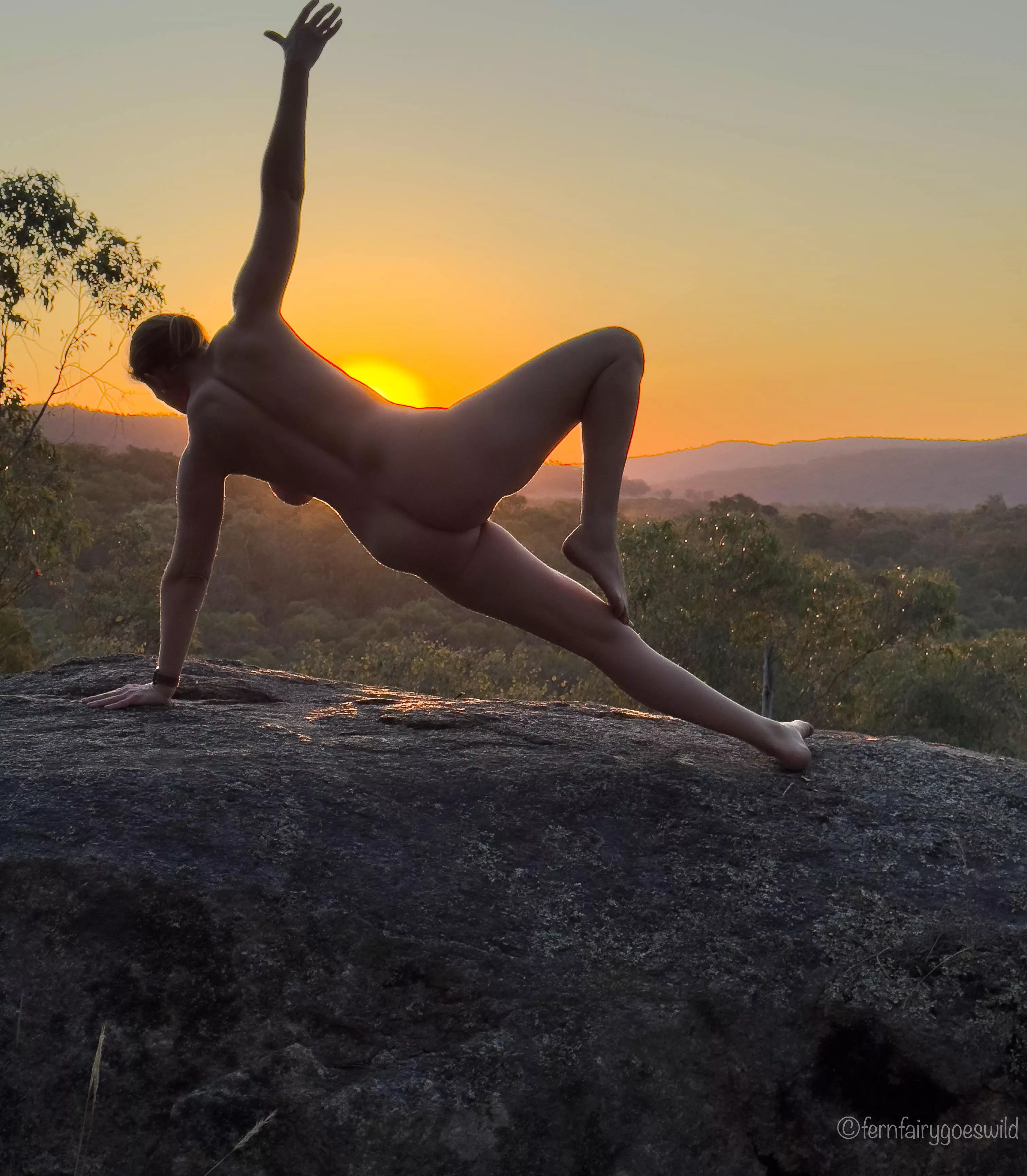 Sunset silhouette nude yoga self portrait on a rock ledge in Australia