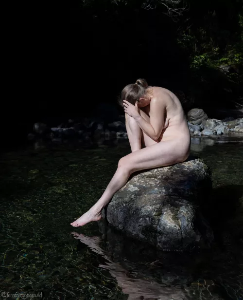 Self portrait on a rock in the river