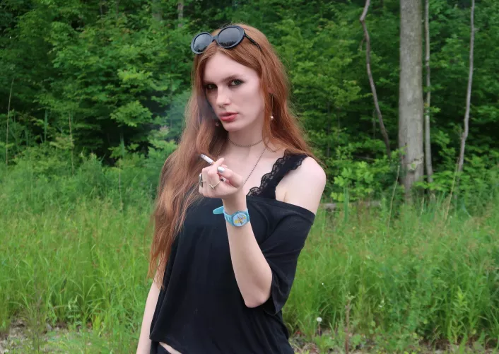 Hot redhead smokes a cigarette