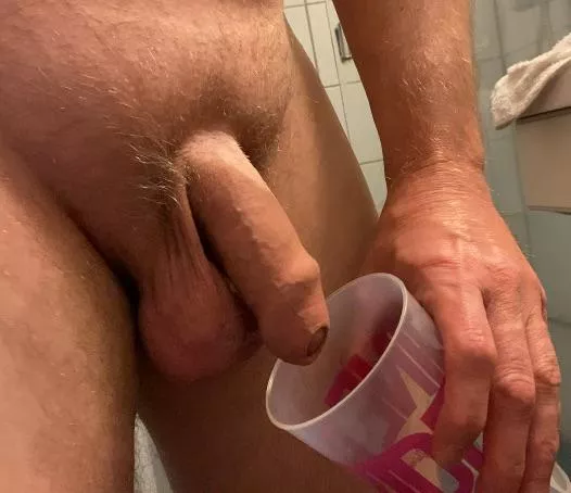 Emptying myself in a cup. Enjoying the sound of myself pissing. 