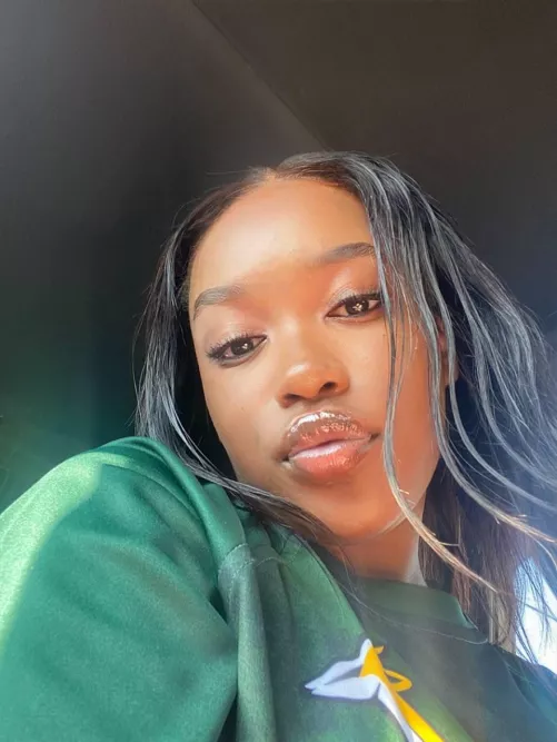 Brown skin, black hair and green hoodie, enjoy