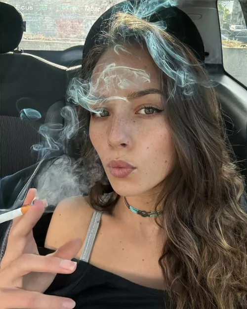 Filling her car with cigarette smoke