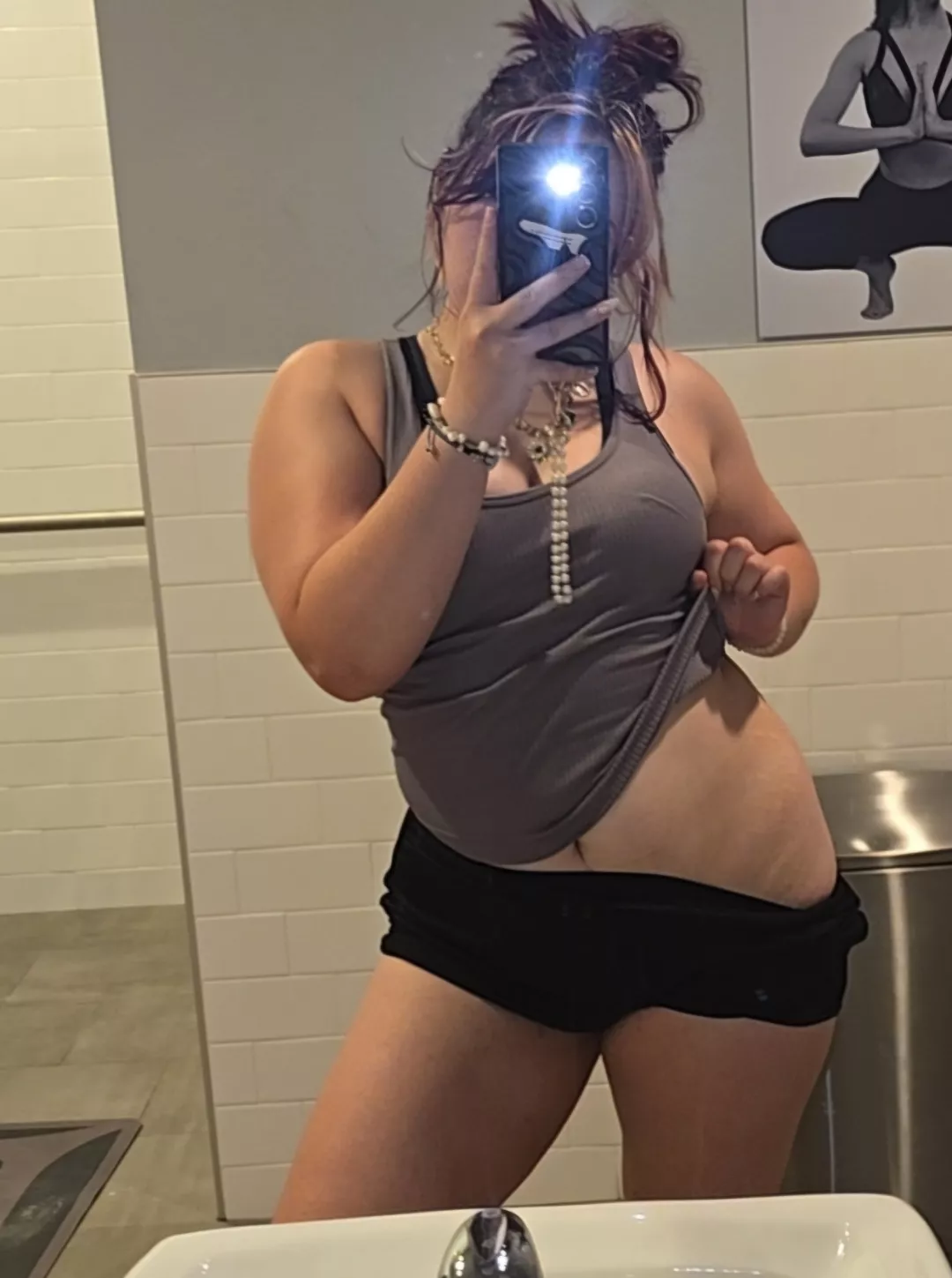 a slightly chubby girl taking a slightly slutty selfie at the gym this morning 