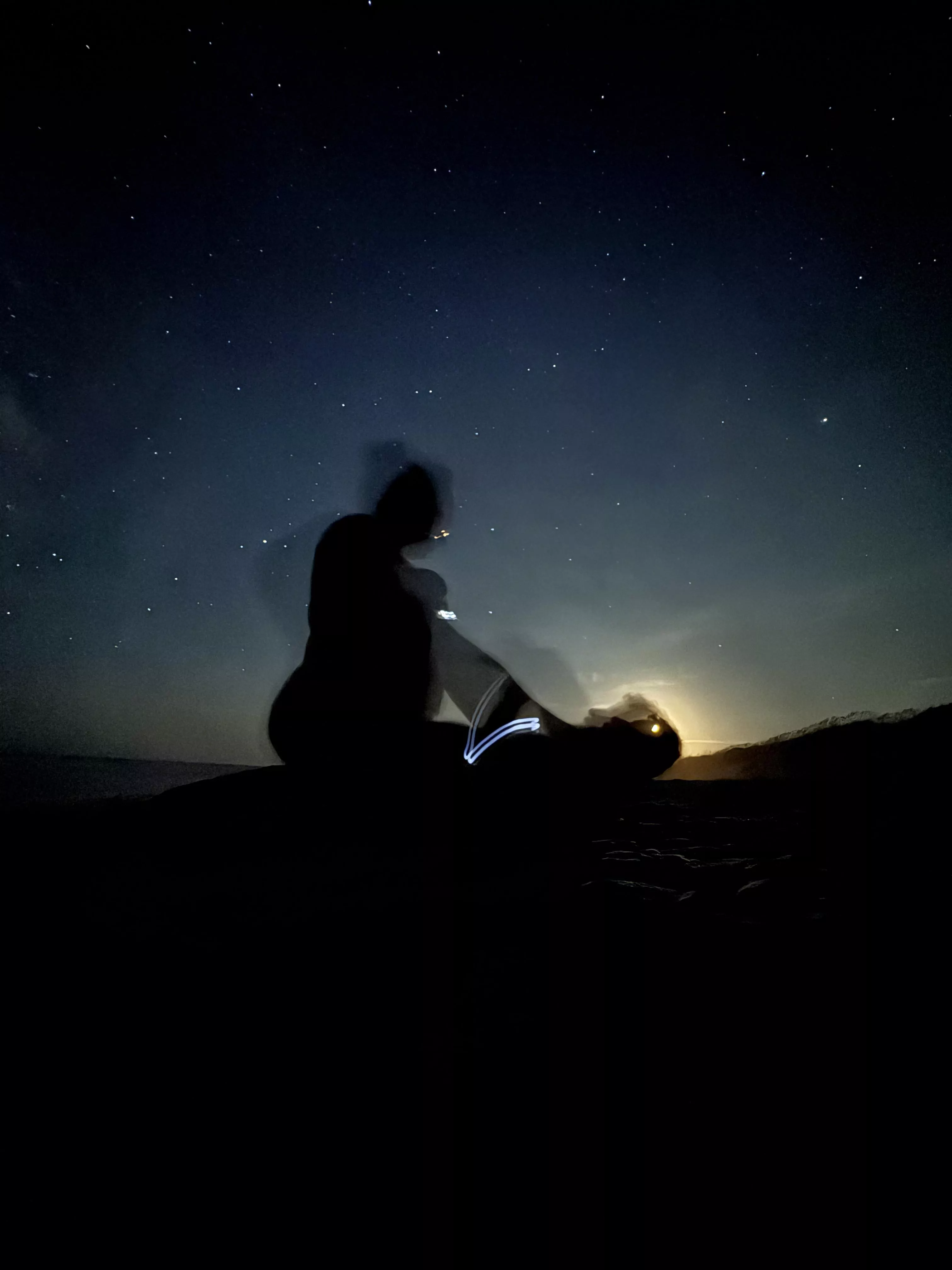 Playing on the beach at midnight, silhouetted against the moon