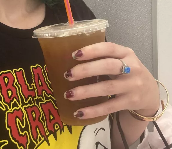 Hand holding a coffee