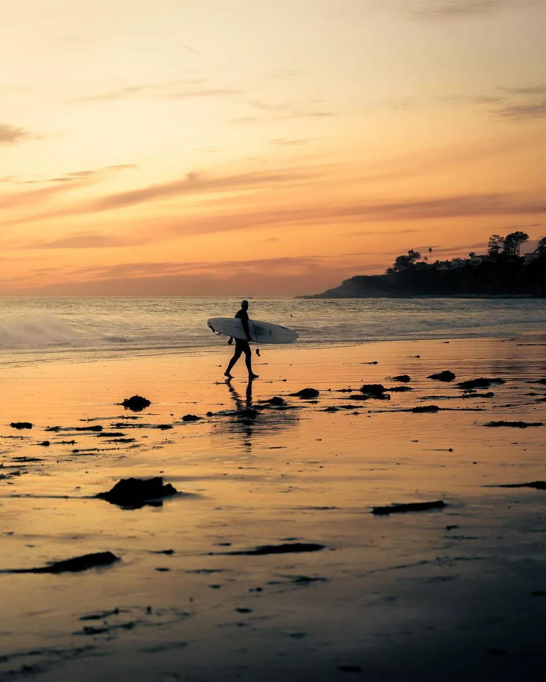 Photo of a surfer at sunset