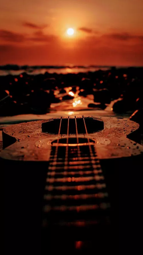 playing guitar with a good sunset