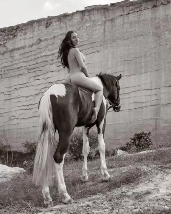 Gracefully bareback riding, showcasing confidence and a stunning sideboob