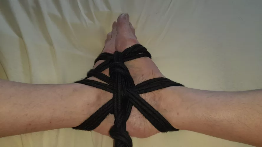 Feet tied with black rope