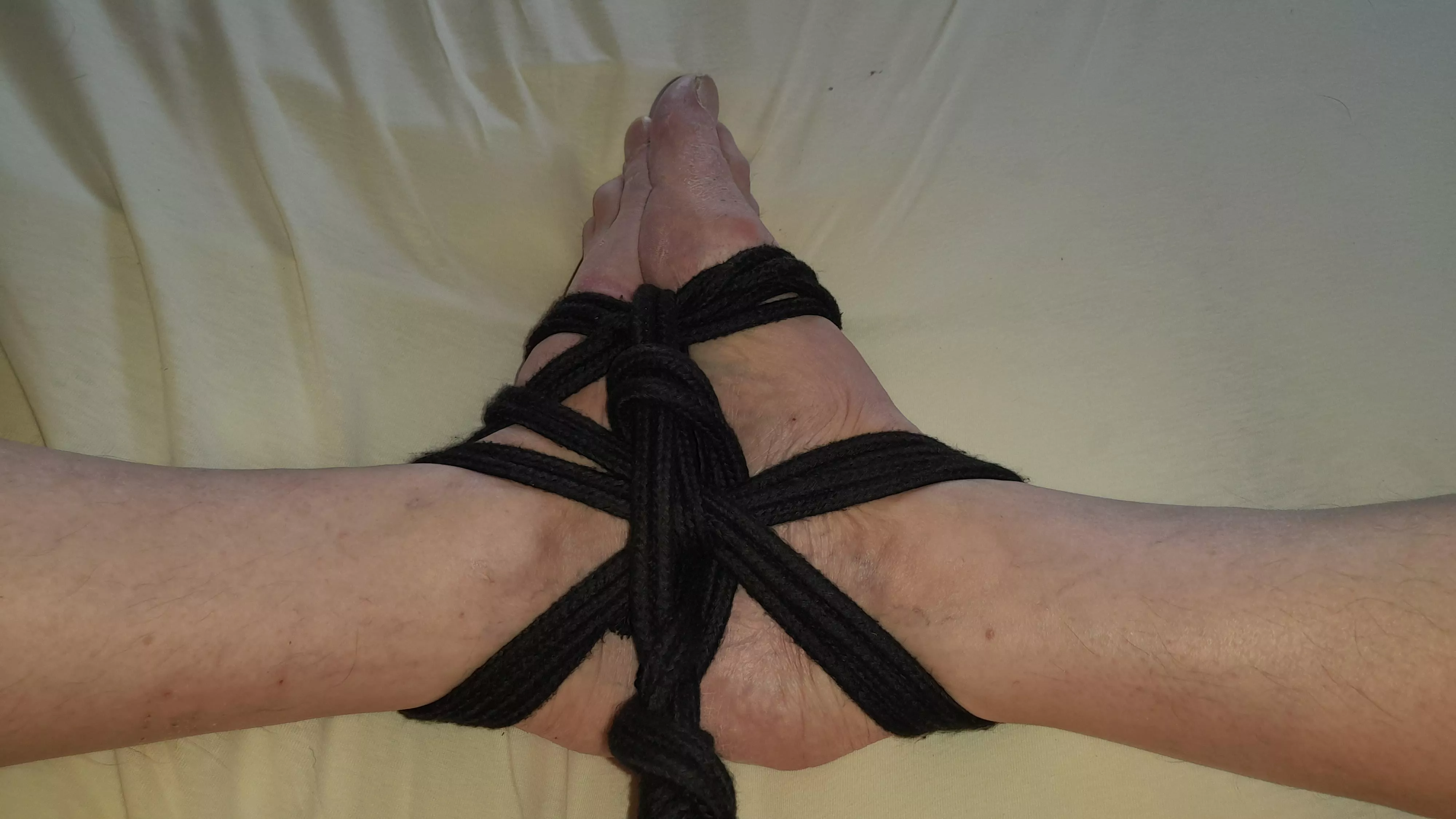 Feet tied with black rope