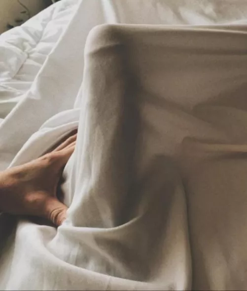 Edging under the sheets next to my sleeping wife