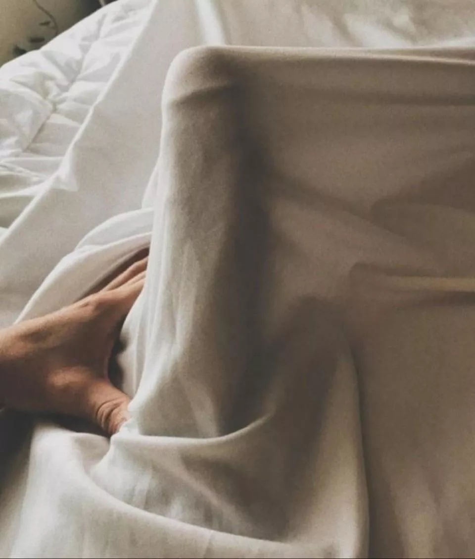 Edging under the sheets next to my sleeping wife