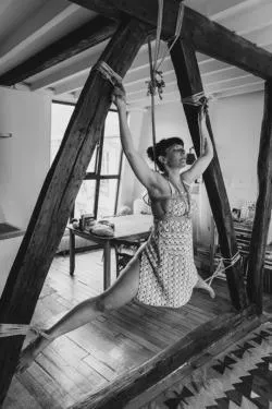 Tied to the beams gives her a sense of weightlessness.