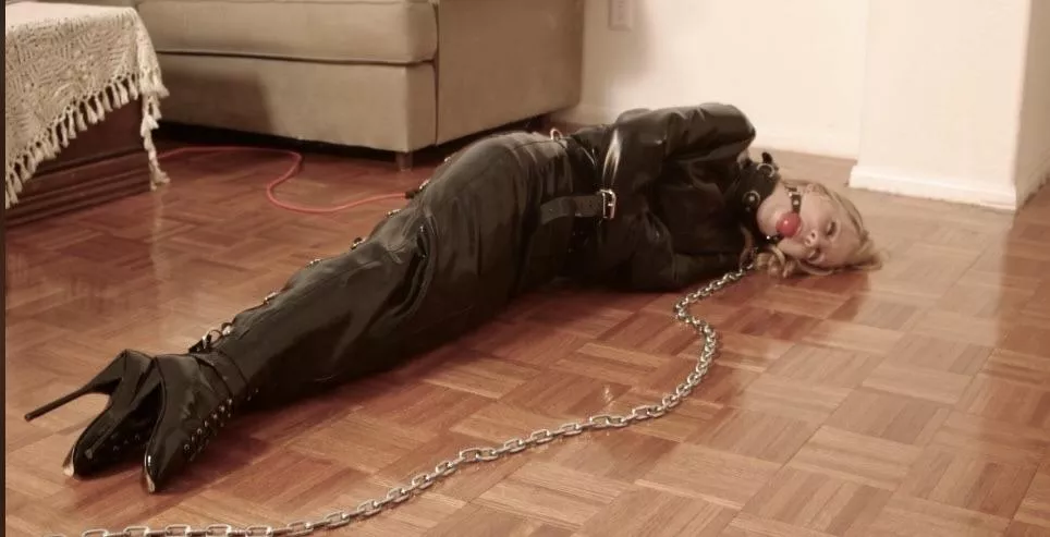 Slave in latex dress and straitjacket. 