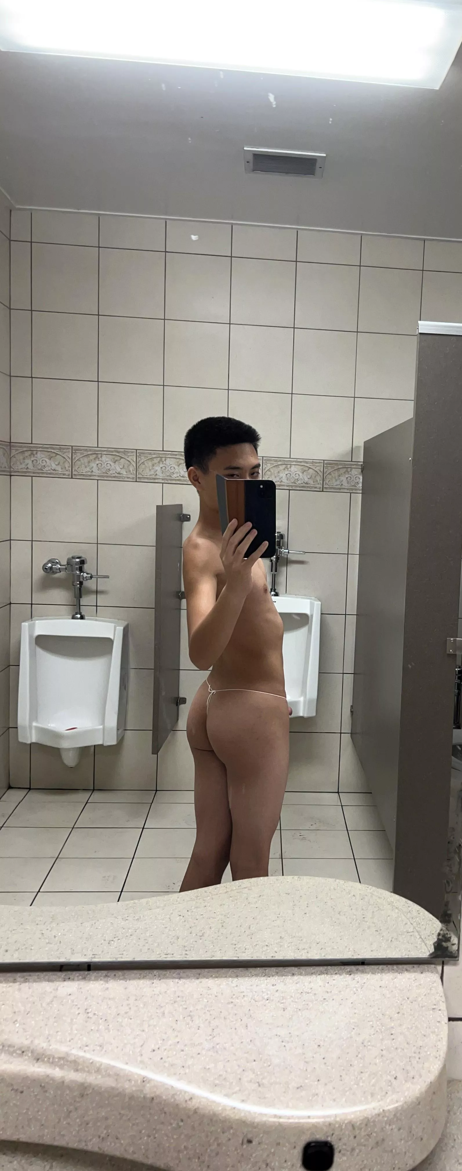 [18] Wearing my g-string in the public restroom at the mall. 