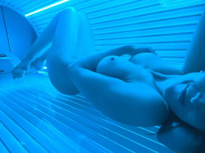 Sun-Kissed Tranquility: Woman in Tanning Room