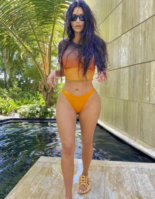 Kim in a gradient print top and orange bikini bottoms 