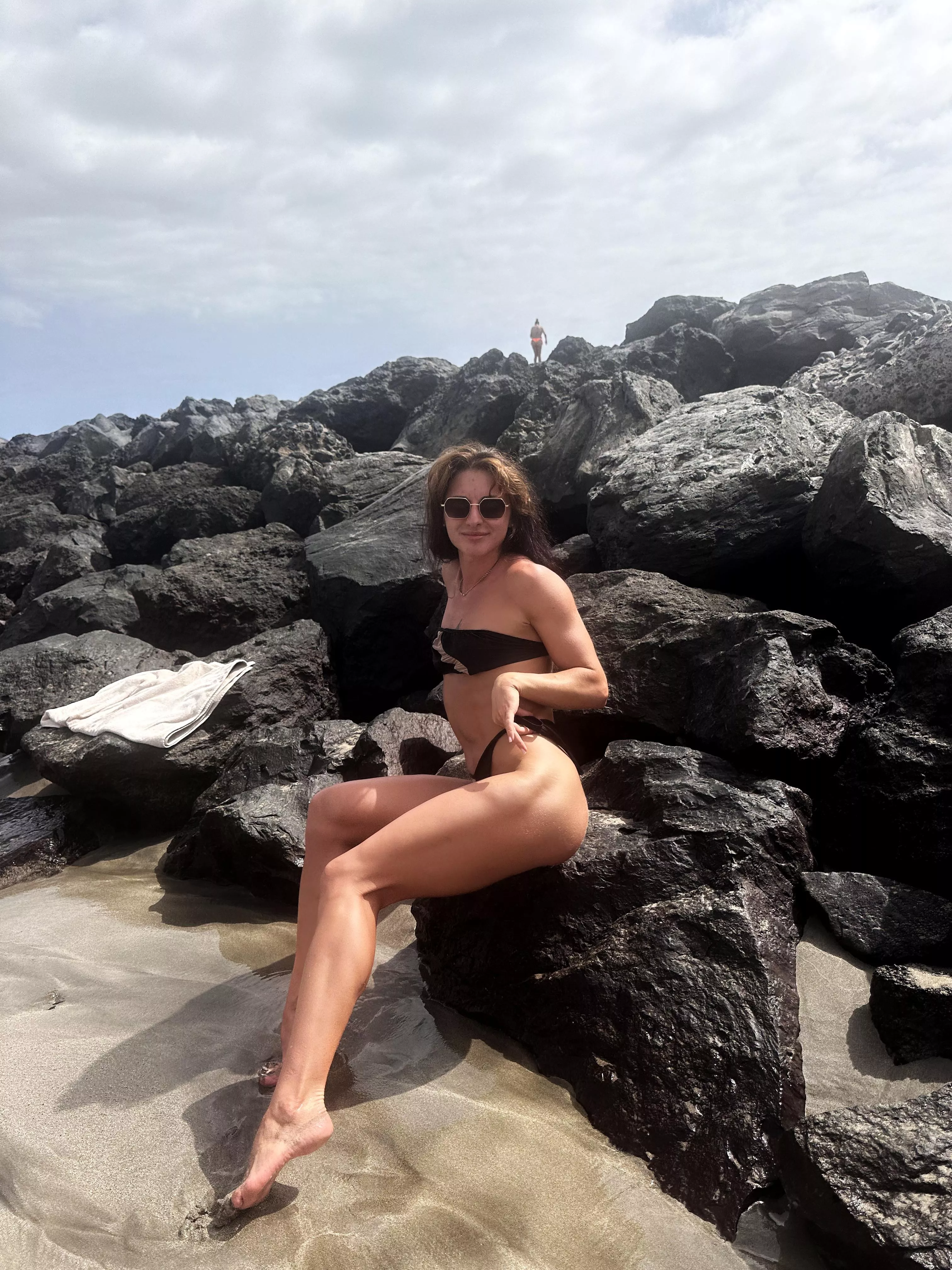 My legs are on the stone beach