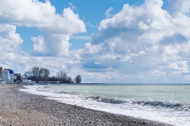 Pebble beach and clouds over the sea