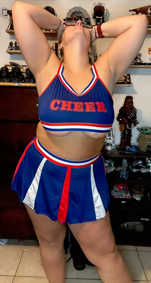 My chubby cheeks blush with excitement as you admire my big boobs, cheerleader style