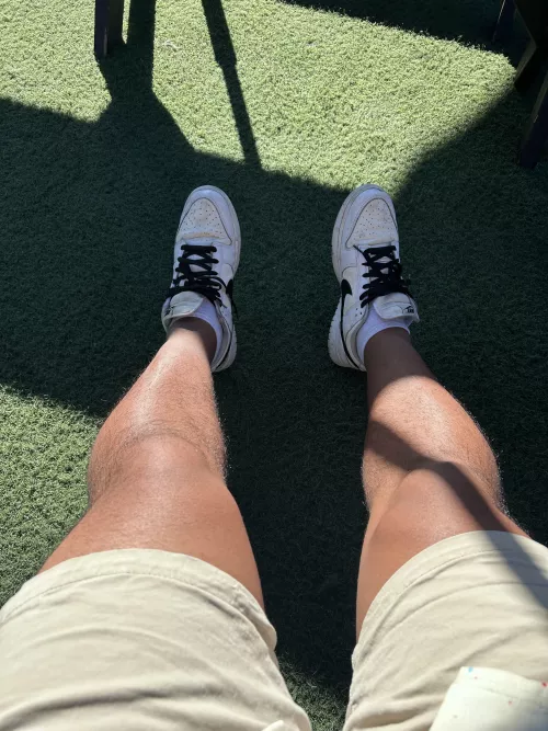 Men’s legs from after lunch. Tanned and under sunlight 