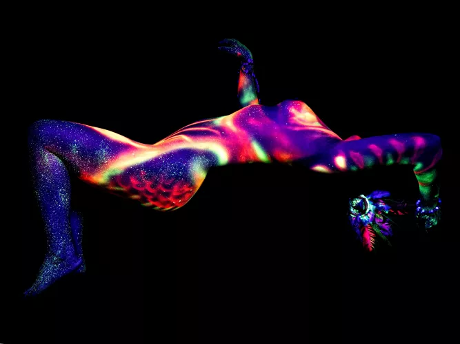 My naked body painted by an artist using fluorescent paint and ultraviolet lighting.