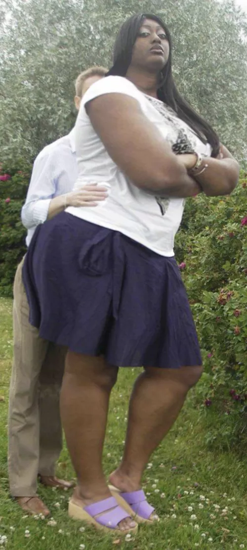 Huge school girl dwarfs her puny coach