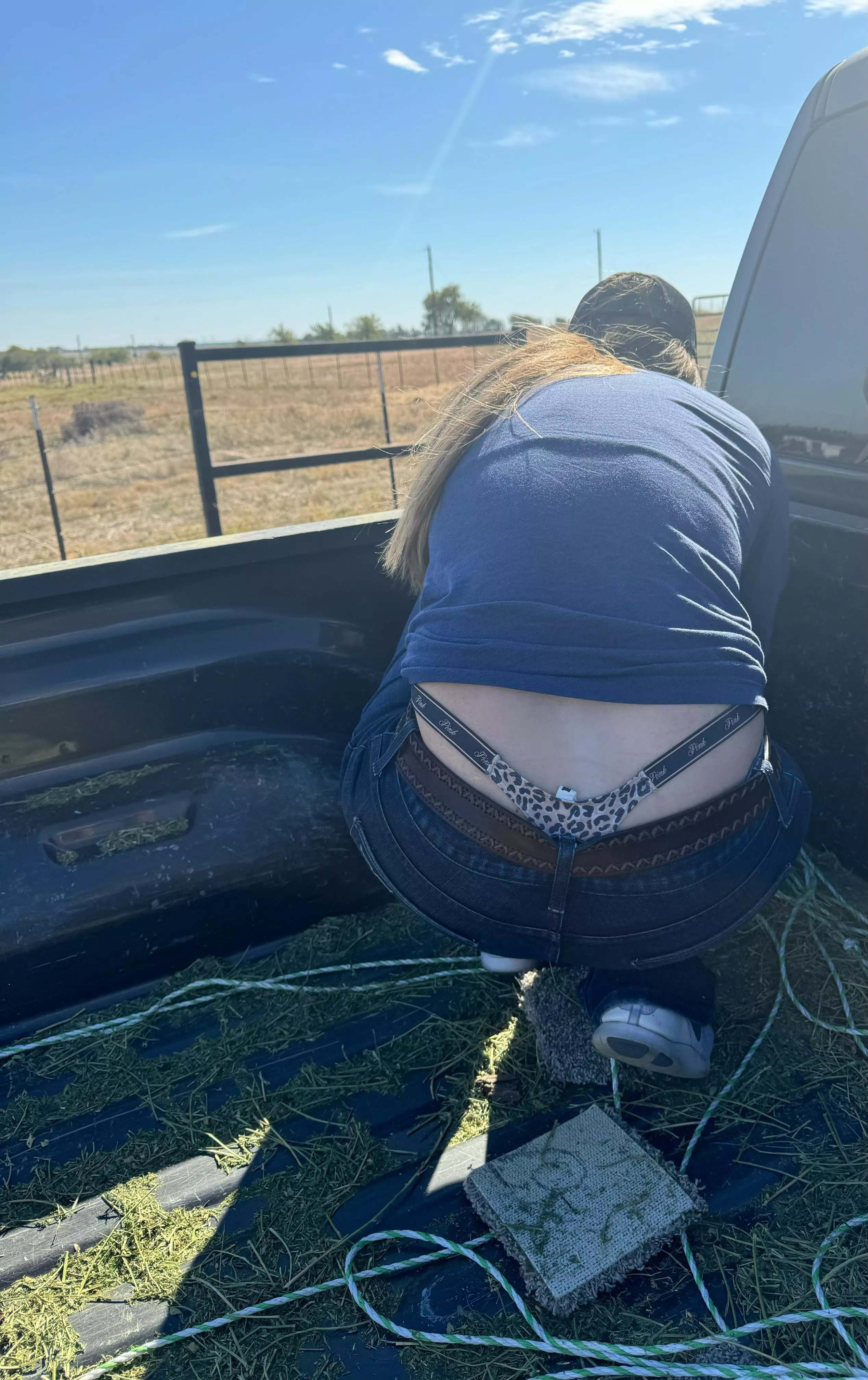 Tail poking out after unloading a truck full of hay🫣