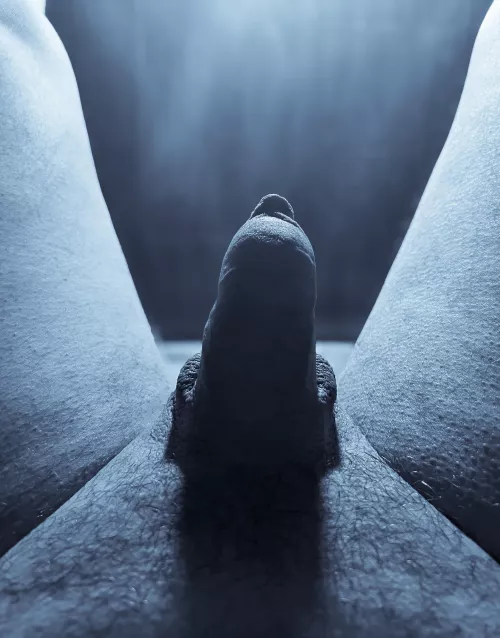 Stooped Figure In A Long Cloak Passing Between Two Large Rock Formations 