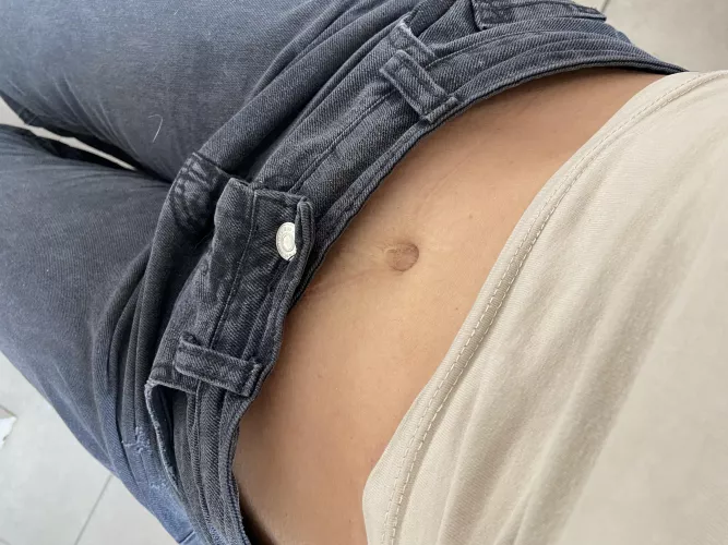 A round and perfect belly button is showing through. 
