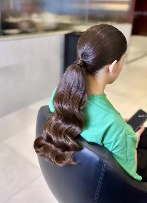 Shiny brown curly ponytail