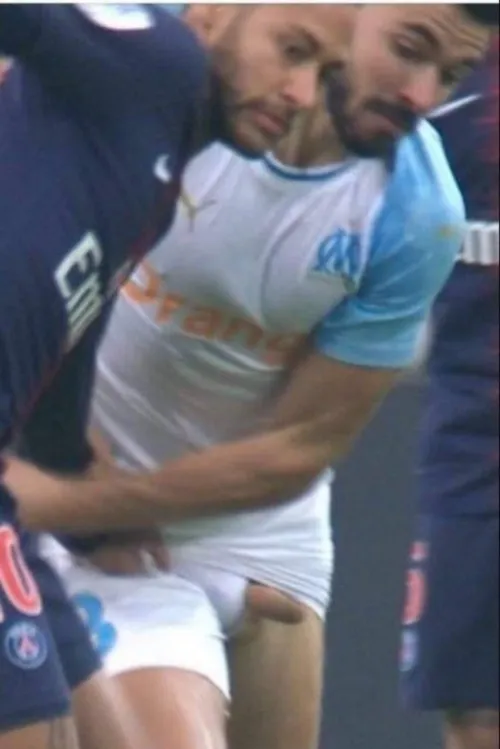 Brazilian soccer player Neymar tugs on the shorts of Morgan Sanson, from Olympique de Marseille, who can't do anything to prevent us from seeing his penis, even when he's wearing underwear.