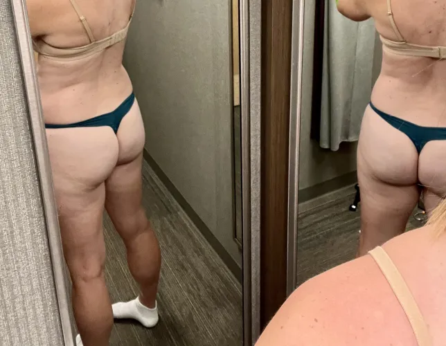 MILF ass in a thong. In a changing room mirror. 