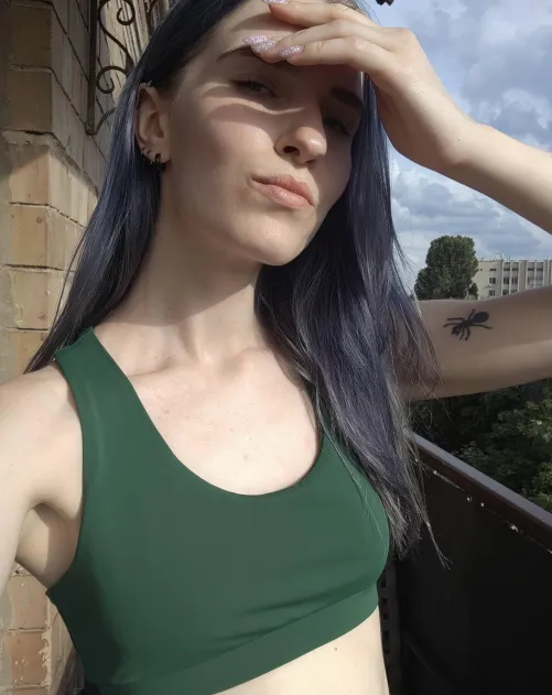 young girl taking selfies on the balcony