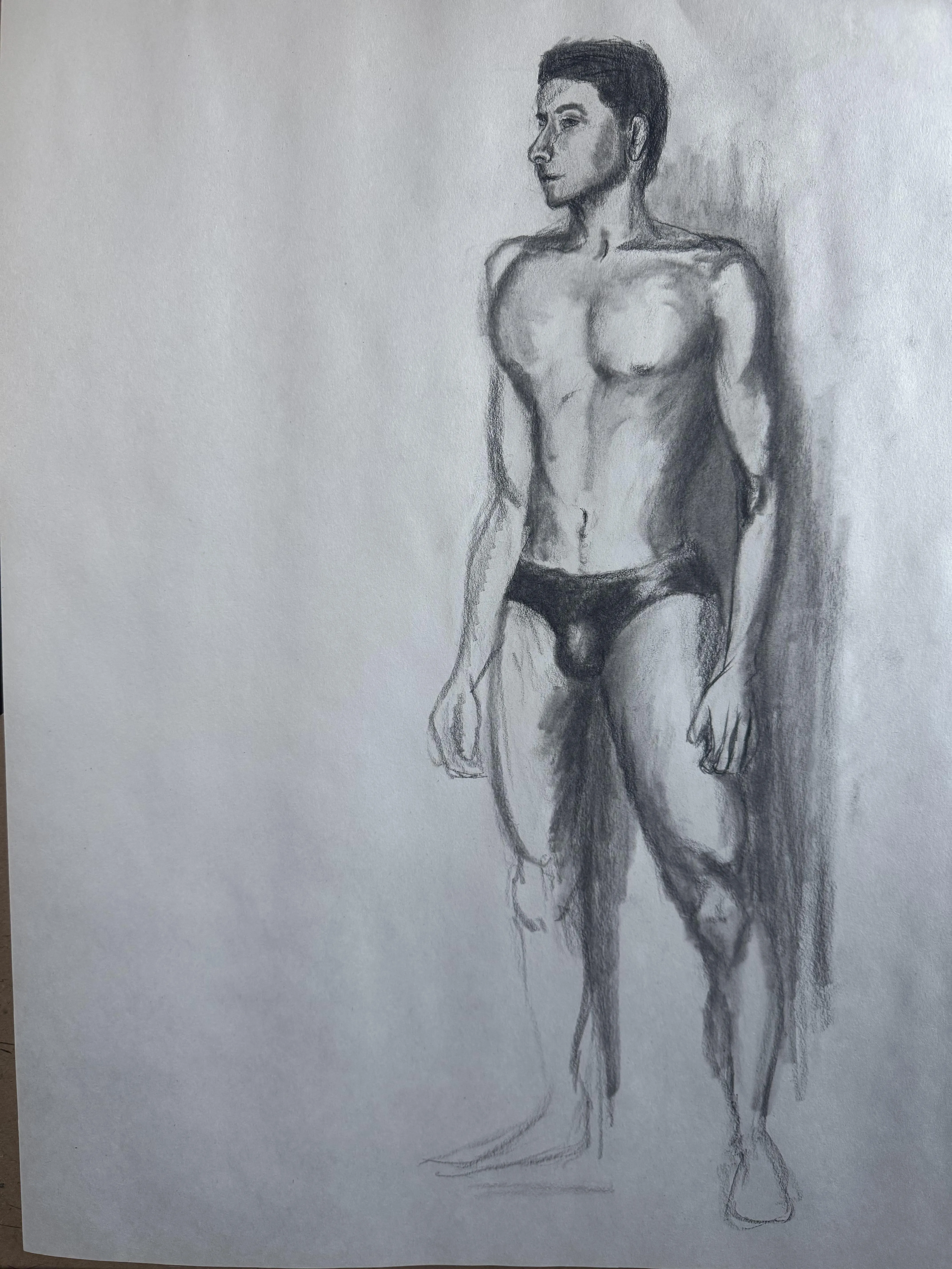 A young man stands proudly in his undies