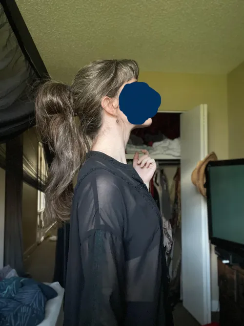 Grown out micro bangs, and a double ponytail that makes the top one a bun. I don't know what the style is called but I love it