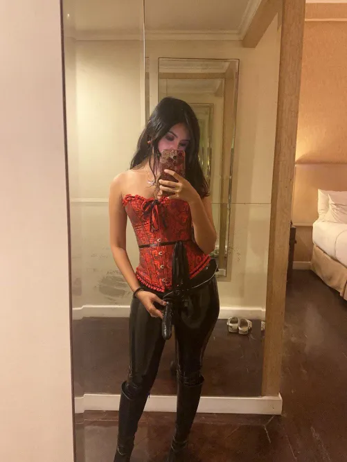 Corset, boots, latex, and strap on at one picture!