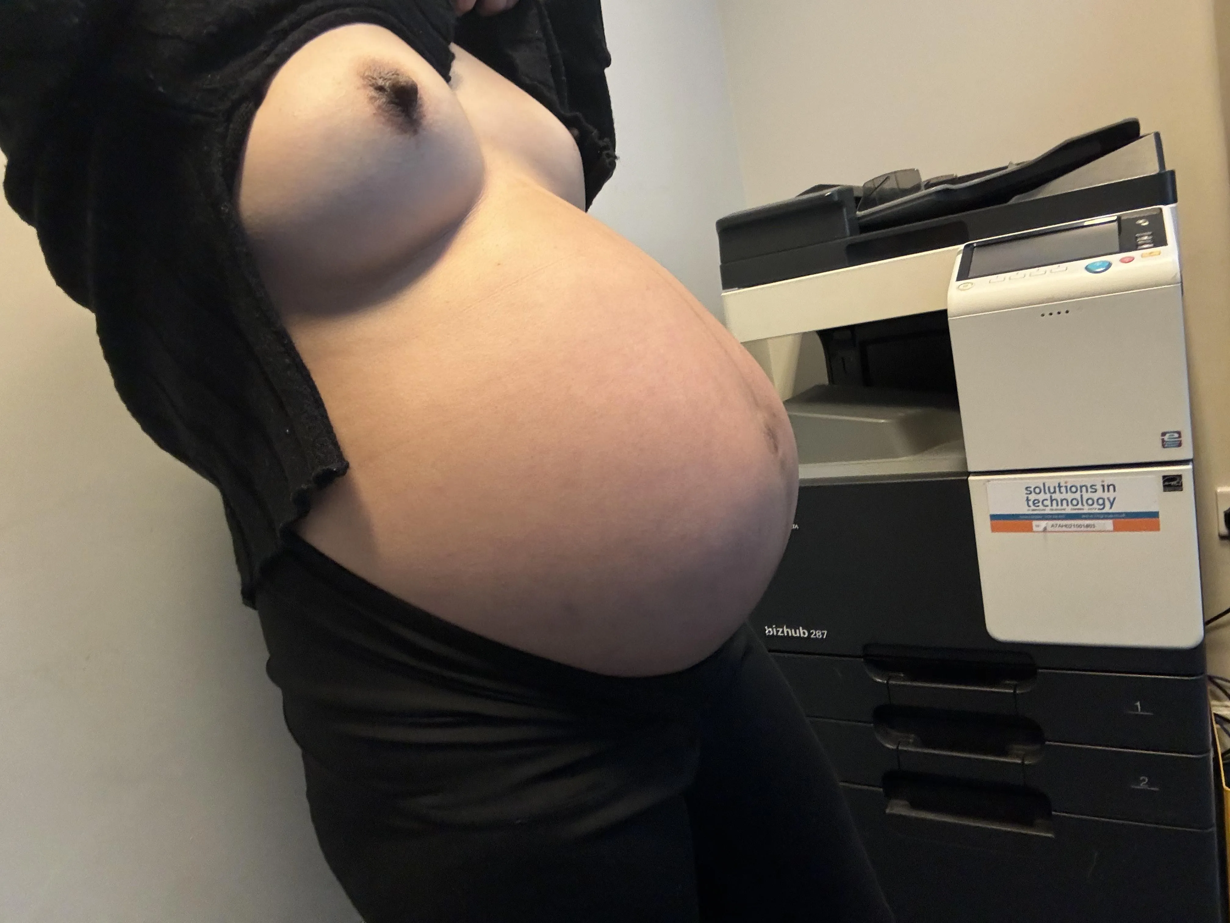 Flashing pregnant tits at the office