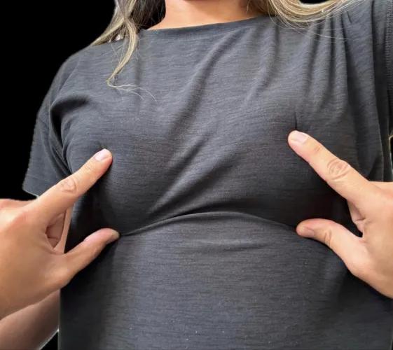 Touching her clothed boobs