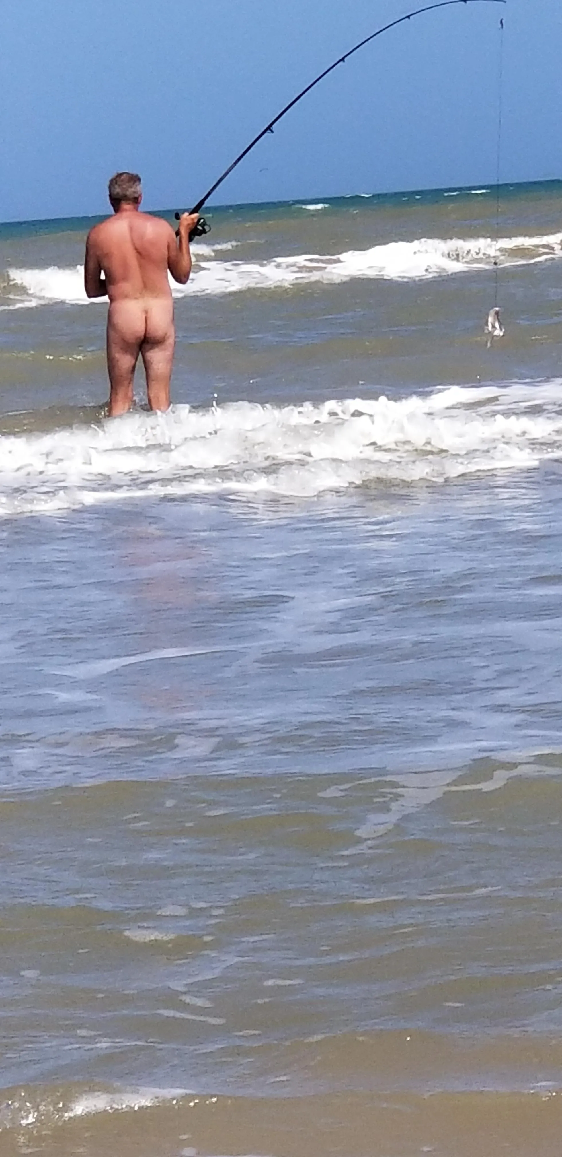 Surf fishing naked.
