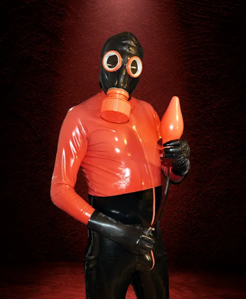 Catsuit, gas mask and toy made of black and red rubber
