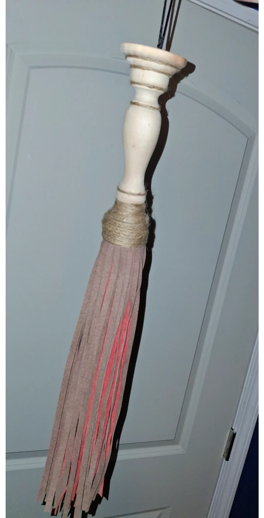 My first flogger. Made of tassles, a candlestick holder, and twine for wrapping.