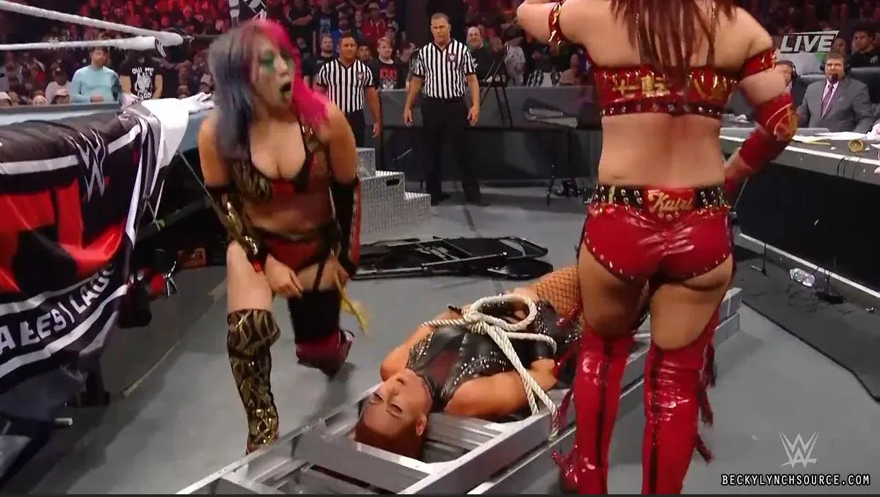Becky Lynch tied up by the Kabuki Warriors