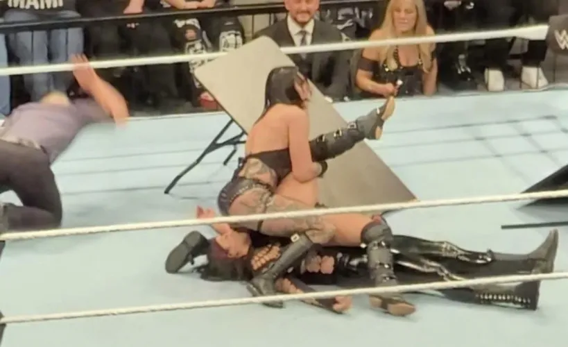 Rhea sitting on liv and raquel